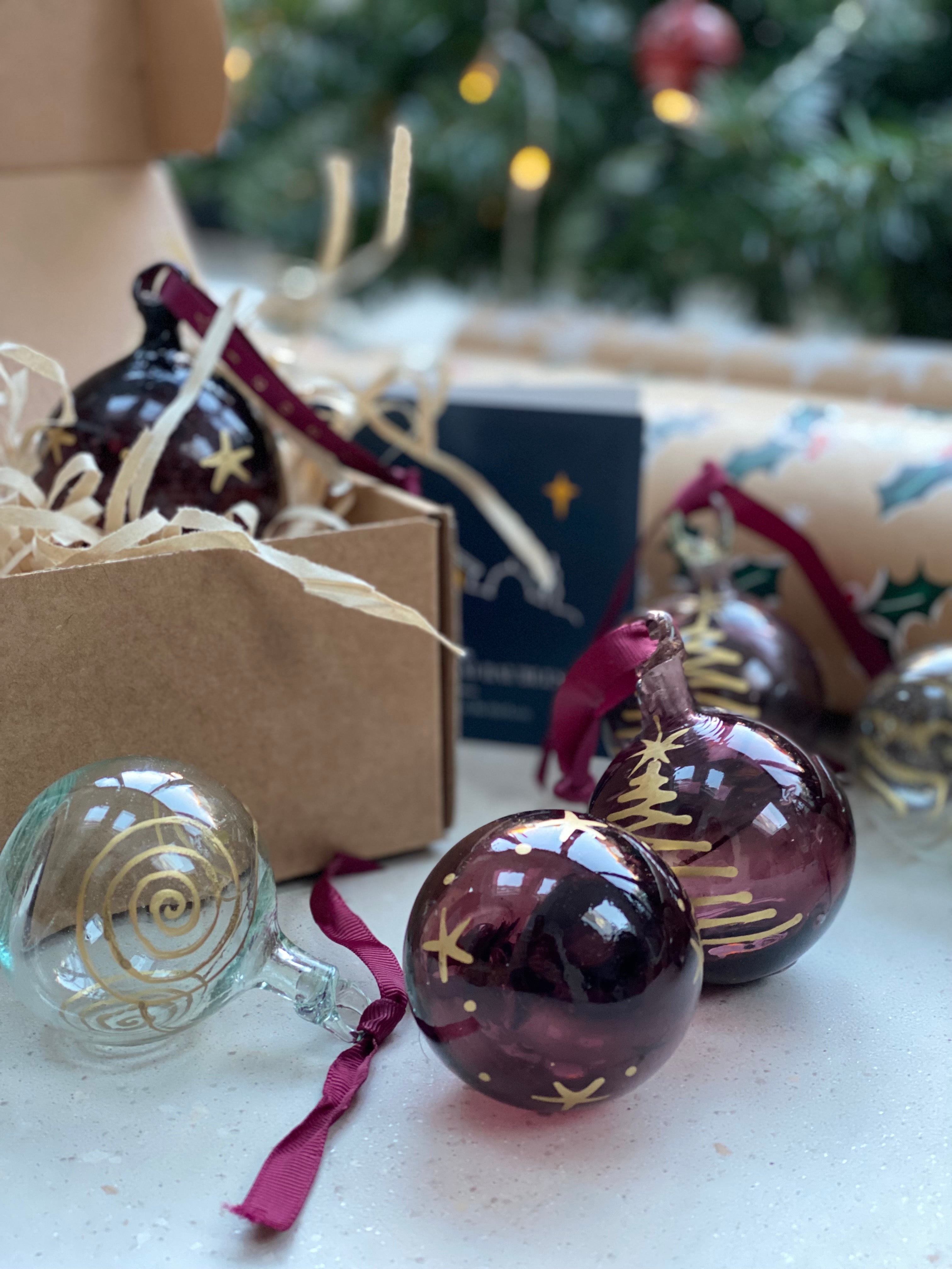 Bethlehem Baubles Clear and plum glass Christmas Decoration with gold squirl and gold ribbon