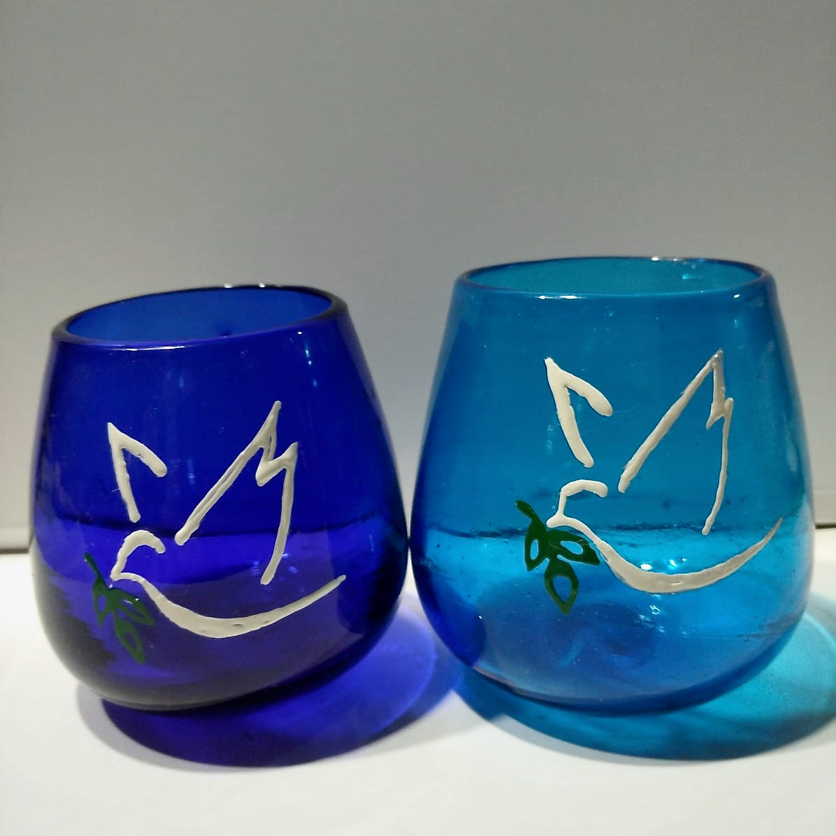 recycled dark blue and turquoise peace light (tea light) with white dove and olive branch painted on side. Made in Bethlehem