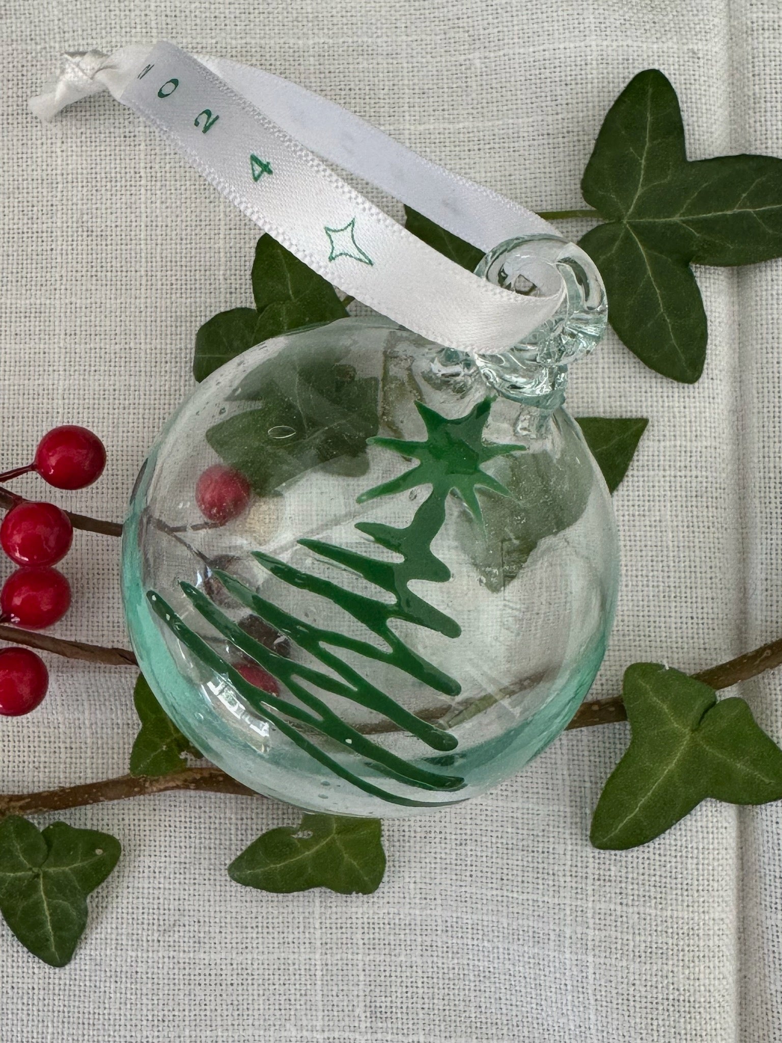 Clear glass recycled Christmas bauble painted with Green Christmas  tree.  Handmade in Bethlehem